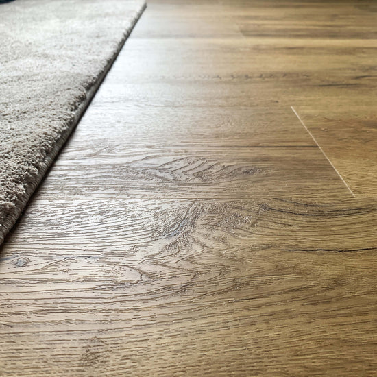 Authentische Holznachbildung in Braun vom Klebevinyl Eiche Vanezia in Raum mit Teppich